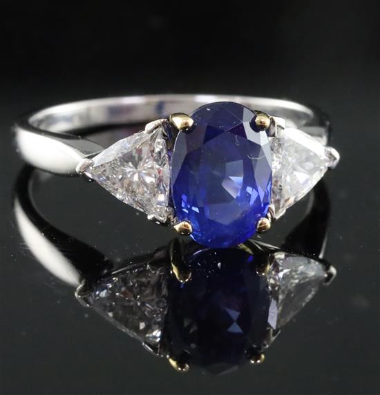 A modern 18ct white gold sapphire and diamond three stone dress ring, size M.